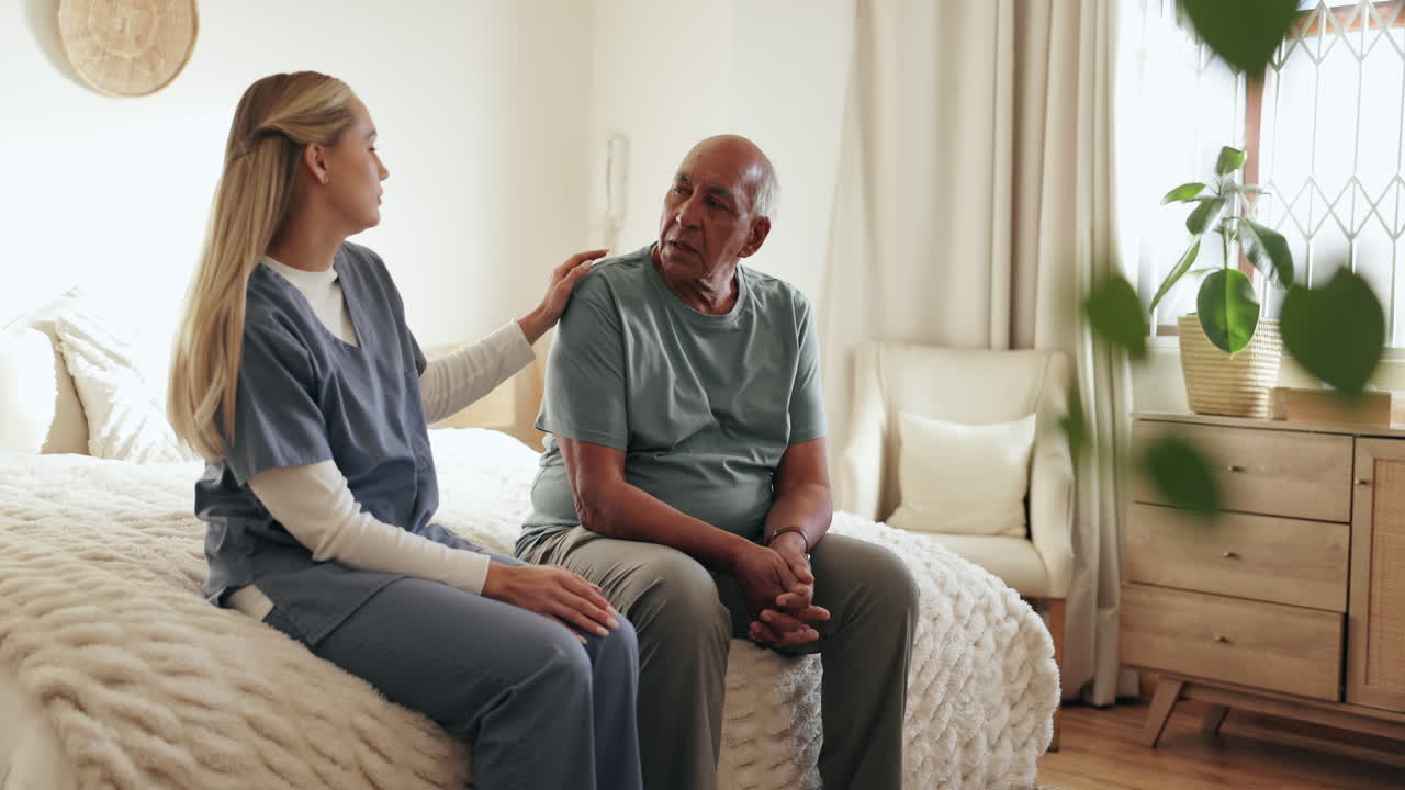 Nurse comforting an elderly patient