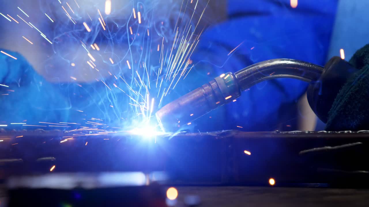 Female welder using blowing torch on a rod 4k