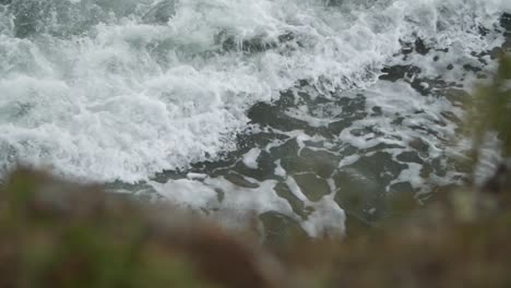 Incoming-beautiful-wave-with-blurry-rock-in-the-foreground