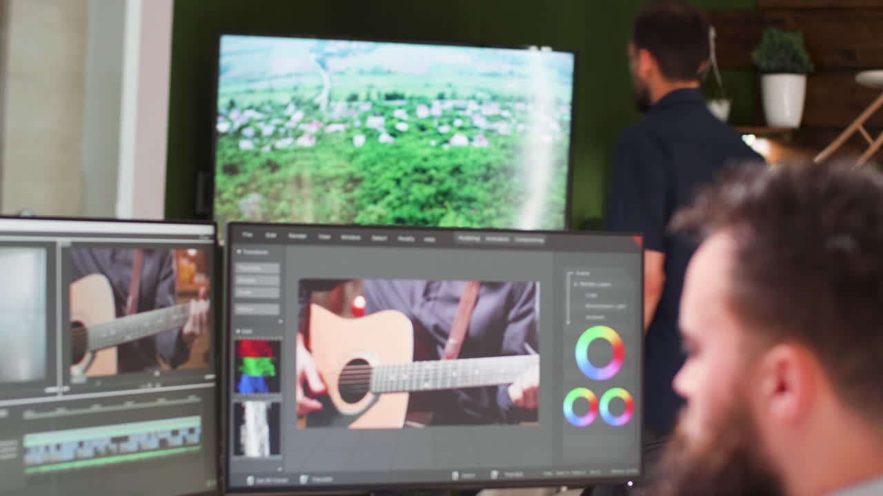 Man working on video editing and color grading on dual monitors