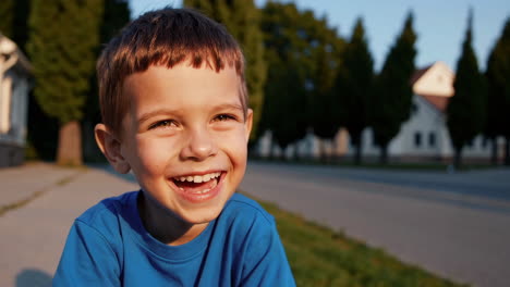 happy young boy laughing outdoors