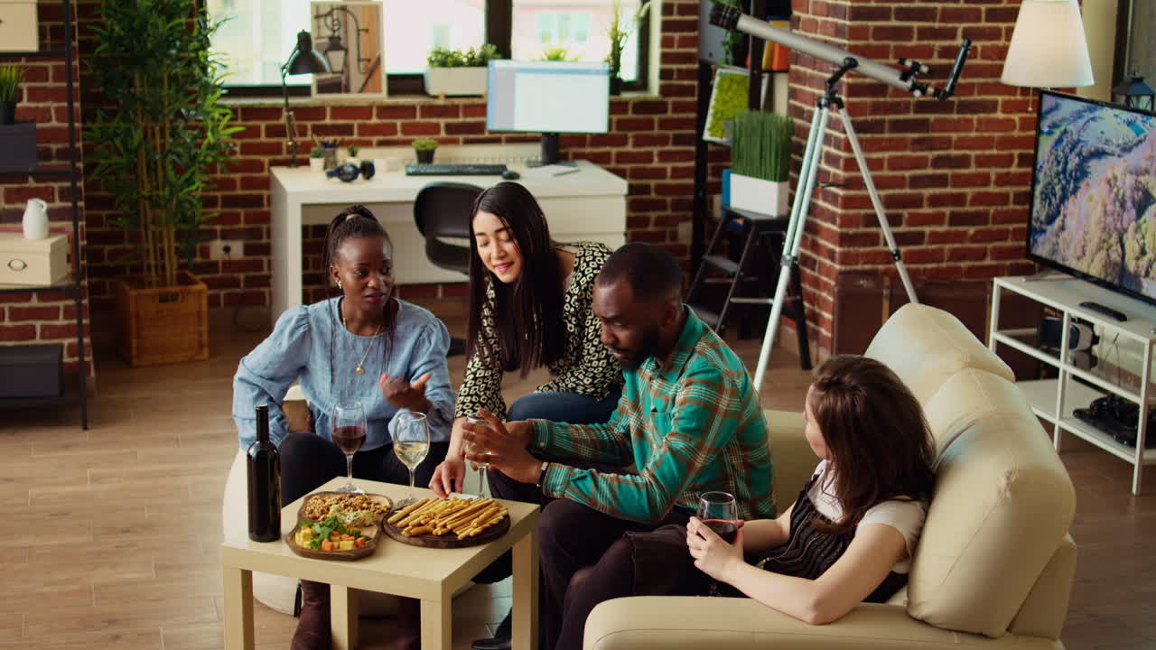 Guests surprising their friend with thoughtful present and enjoying appetizers