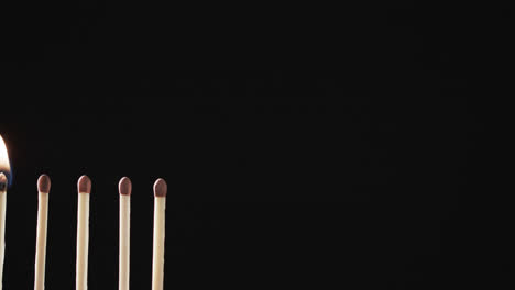 Video-of-matches-with-yellow-fire-flame-and-copy-space-on-black-background