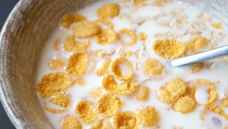 corn flakes mixed with milk in a bowl