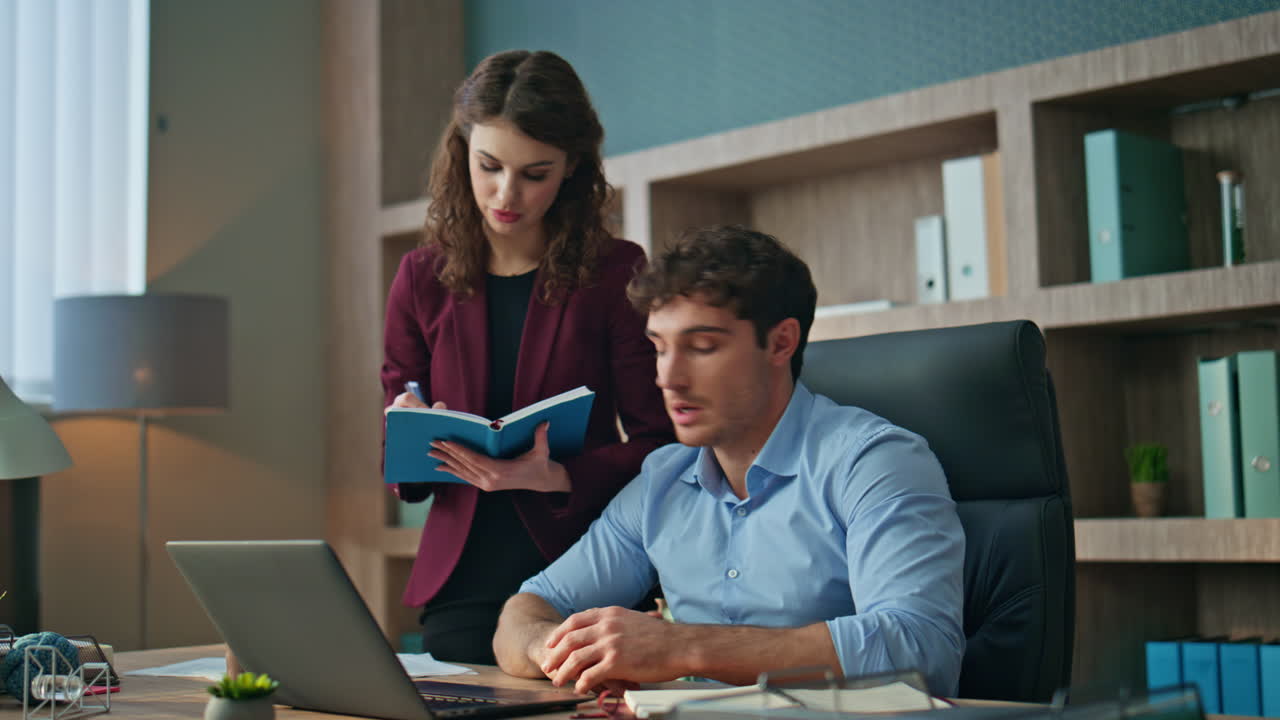 Secretary writing boss instructions standing company office. Ceo giving tasks