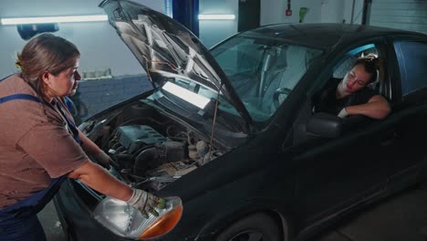 woman mechanics working on a car