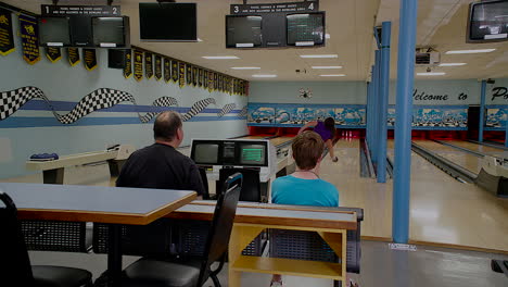 three having fun people bowling