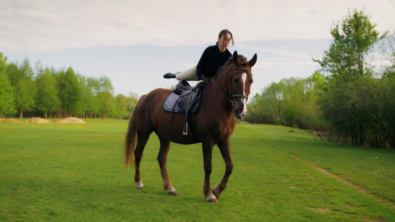 Woman horseback riding in a field