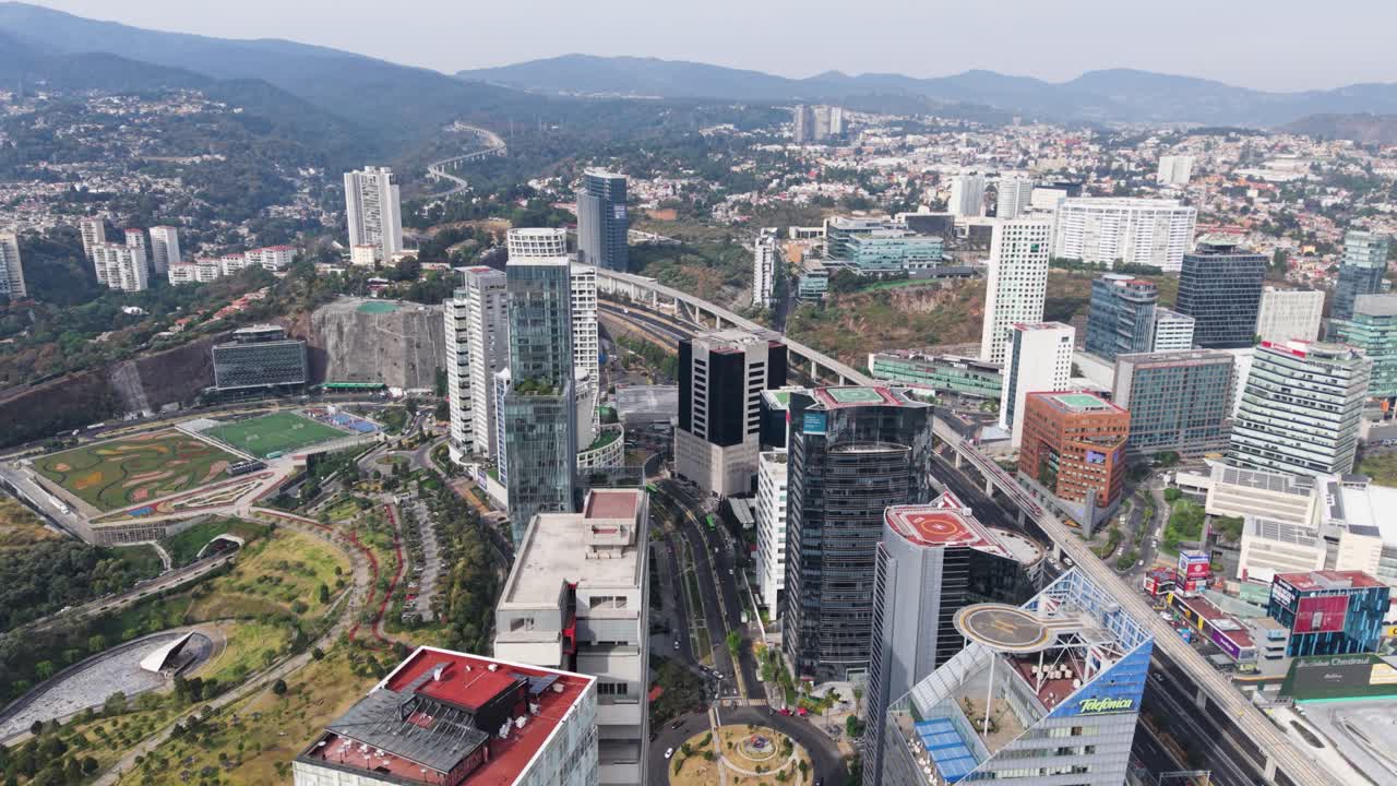 Drone flight over tallest buildings in Santa Fe, overlooking rooftops and helipads. Mexico City