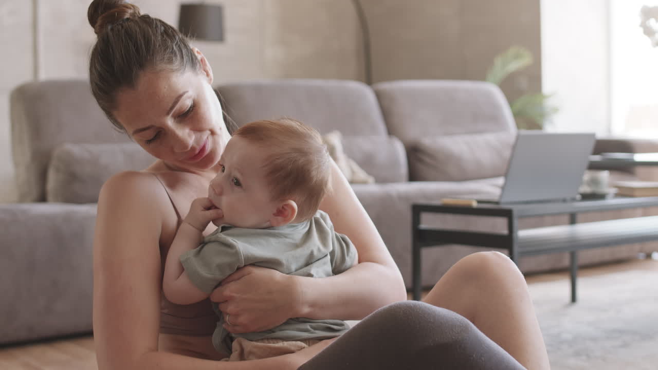 Loving Mother Hugging and Kissing Child