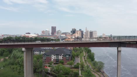 Super-wide-aerial-rising-dolly-shot-of-cars-on-High-Bridge-crossing-the-Mississippi-River-with-downtown-Saint-Paul,-Minnesota-in-the-background