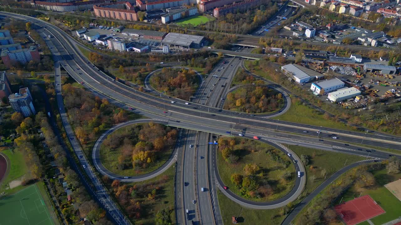 Complex urban highway freeway interchange with cars traversing roads in Berlin. Beautiful aerial view flight wide orbit overview drone