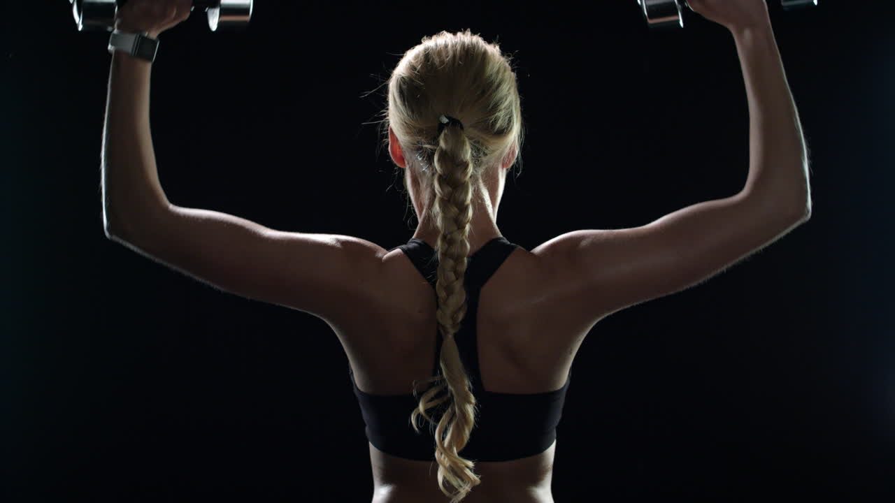 Sport woman training with dumbbells