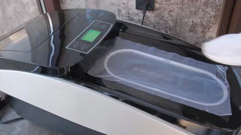 closeup of a man putting on shoe covers in an automatic machine closeup of a man putting on shoe covers in an automatic machine the concept of cleanliness and hygiene
