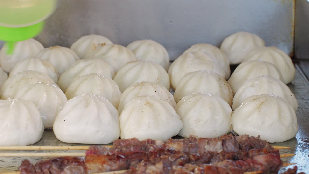Cooking asian baozi with meat on desk close -up. Steaming Technique.. Street food Chinese and Korean pyanse, fast street food local festival
