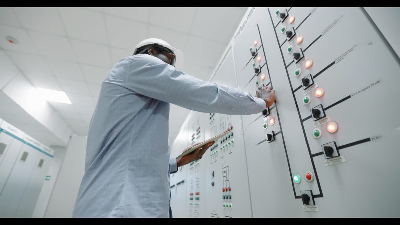 Engineer Monitoring Control Panel in Power Plant