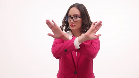 woman in pink blazer making stop gesture