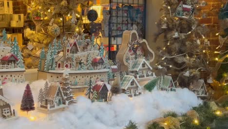 little snow village display in shopping center glass window during holidays on christmas in ashland, oregon, usa