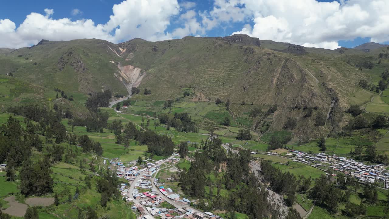 Aerial tilts above Cajatambo to lush mountains in beautiful Peru valley