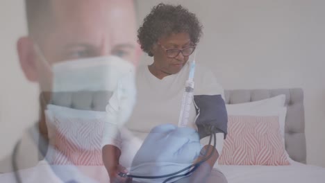 Animation-of-male-doctor-in-face-mask-preparing-vaccination-with-female-patient-in-hospital