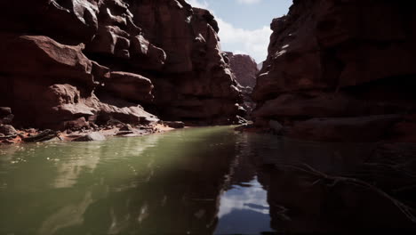 a narrow canyon with a river flowing through it