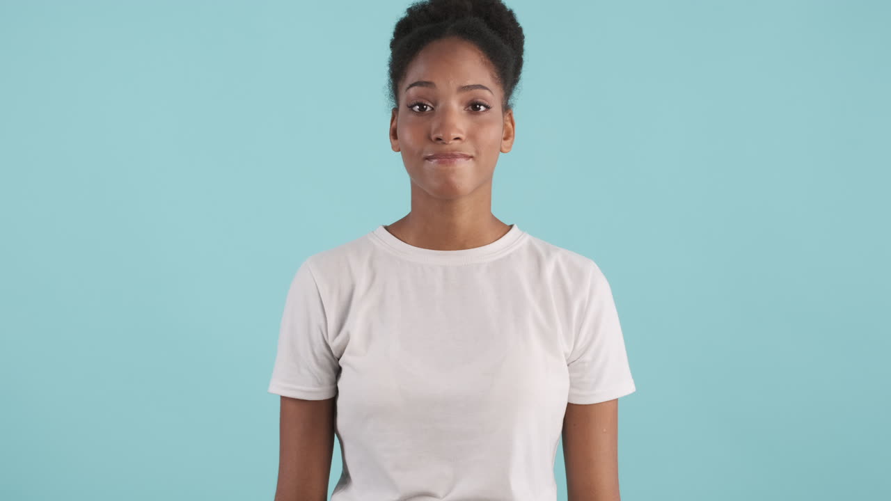 Young woman thinking and rolling her eyes