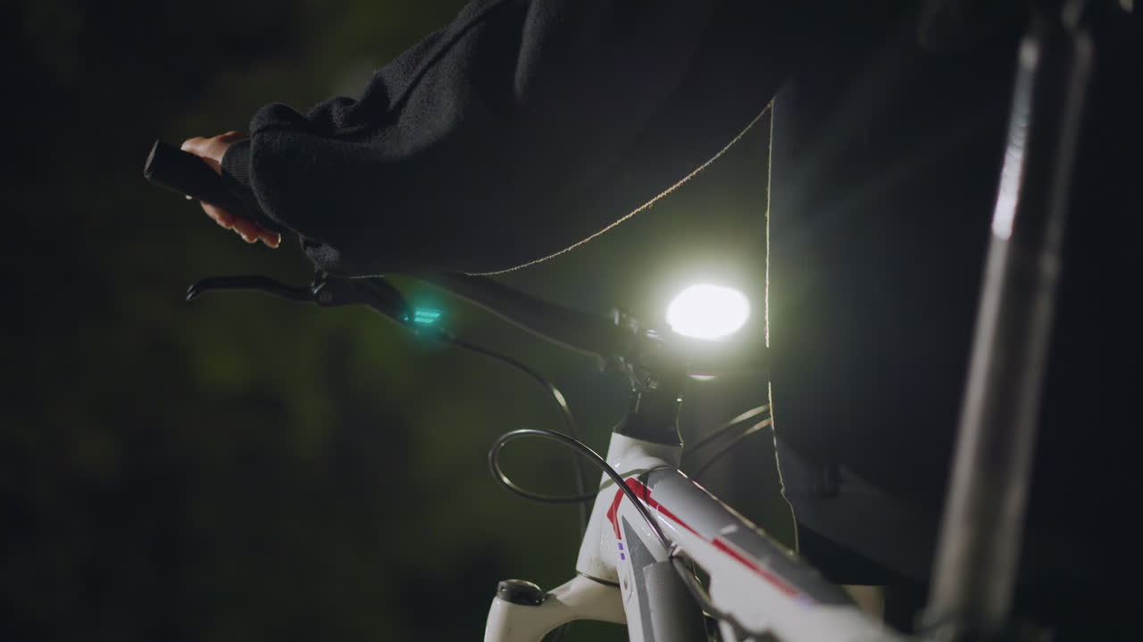 Reflective Bike Under Evening Light, Closeup Of Saddle With Reflective Highlights During Tranquil Evening, Serene Scene Featuring Stationary Bike Illuminated By Bright Lamp In Park Setting