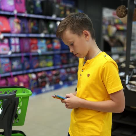 boy buying stationery for school