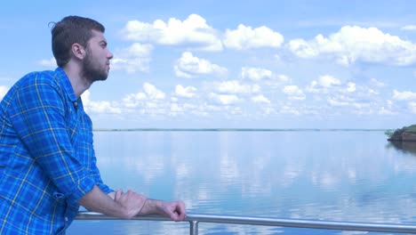 man looking at a lake