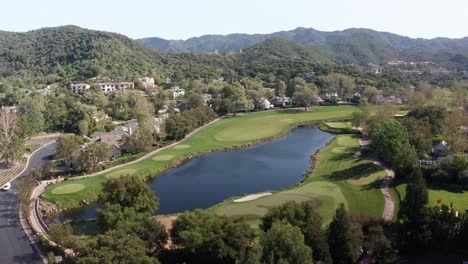 low panning aerial shot of the sherwood country club golf course in southern california. 4k at 30 fps
