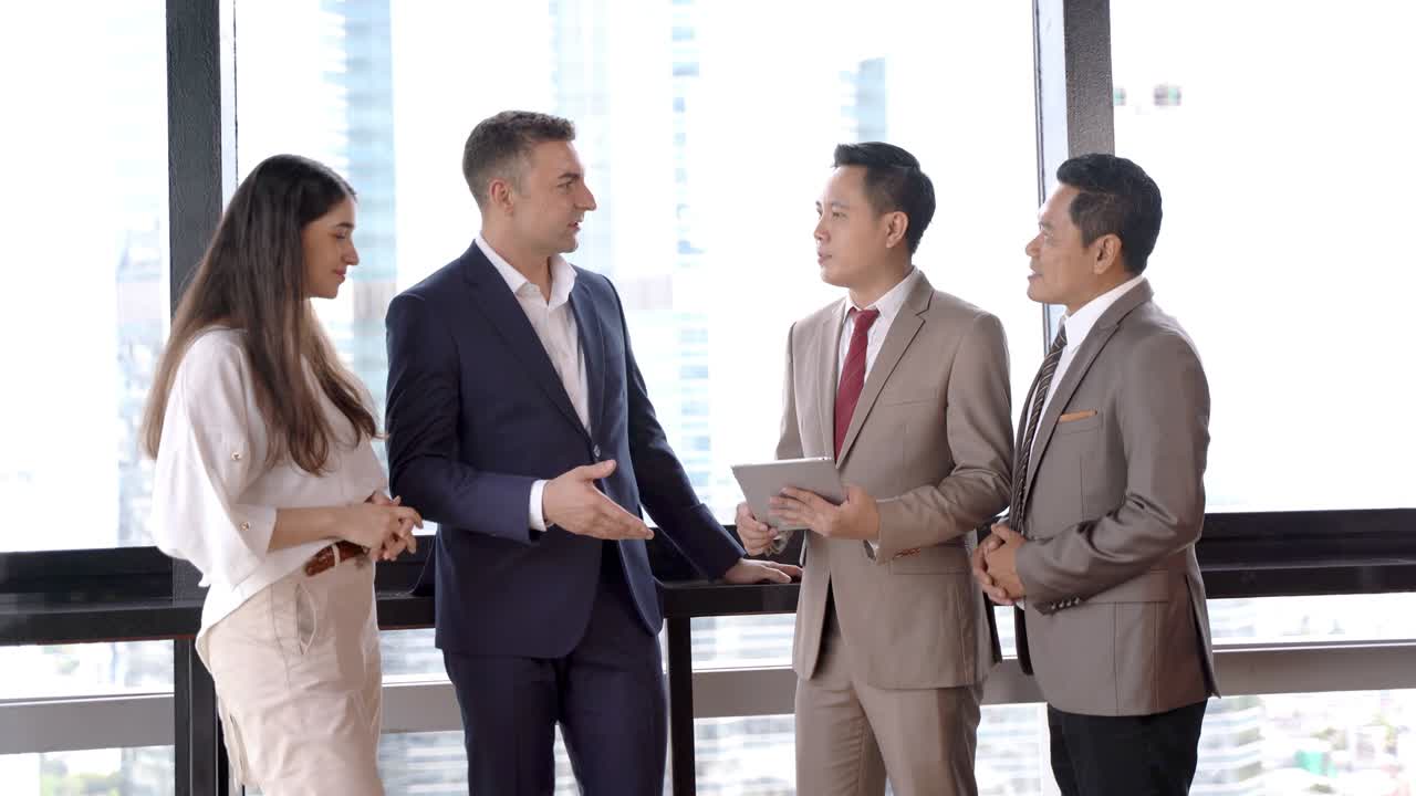 group of successful executive business team talking and shaking hand to celebrate. Diverse business people meeting together at outdoor skyscraper.
