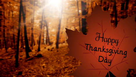 digital composition of happy thanksgiving day text over autumn maple leaf against autumn trees