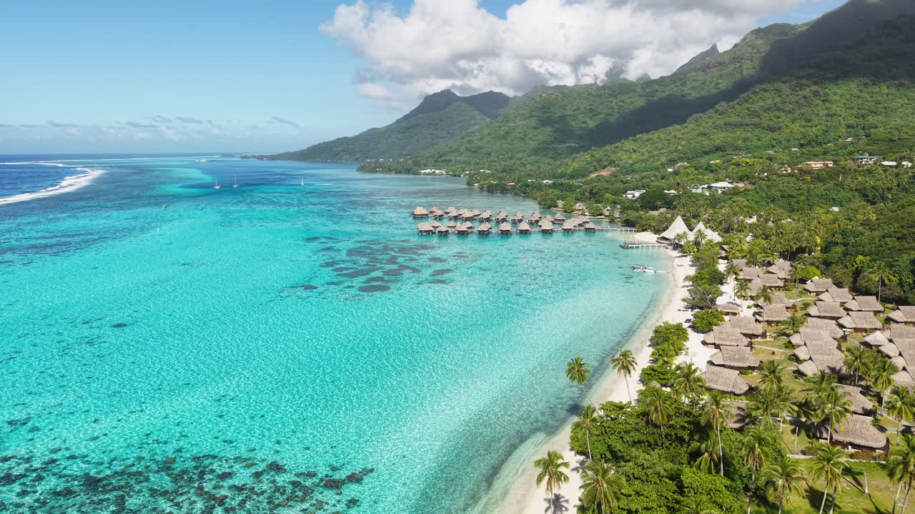 Moorea Island Lagoon and Coastline, French Polynesia. Drone Shot of Luxury Tropical Resort and Overwater Bungalows