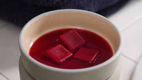 timelapse of wax cube melting in bowl