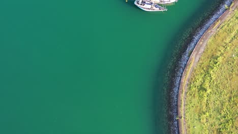 Cinematic-aerial-tilt-up-shot-from-telaga-harbor-marina-reveals-beautiful-mountain-landscape-and-strait-of-malacca-at-langkawi-island,-kedah,-archipelago-of-malaysia