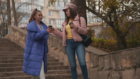 female friends talking and laughing while walking down the street 1