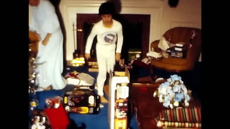 family standing in 1970s room. circa usa - 1970s: a family standing inside a room captured in a 1970s video footage from the usa.