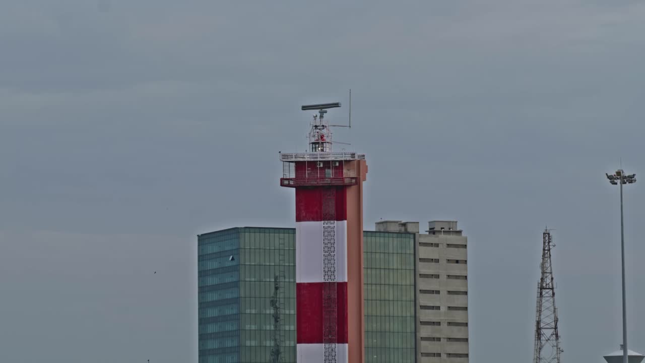 Chennai Lighthouse in marina beach with JM Marina, marine towers, light pole and signal tower at Marina Beach, Mylapore, Chennai, Tamil Nadu, india. day time, close up shot, 4k