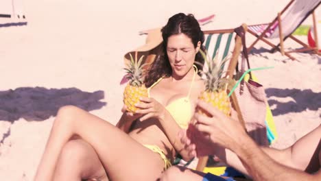 cute couple on holidays drinking cocktails