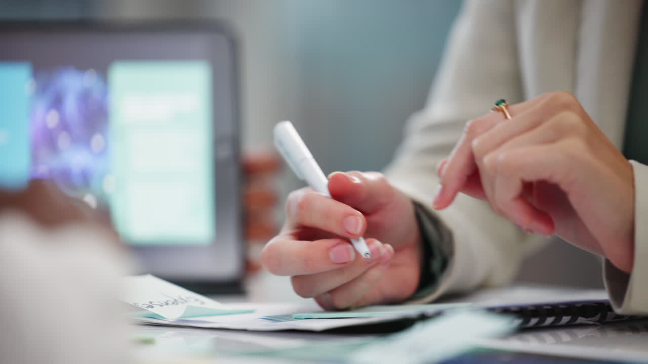 Woman writing on paper in office