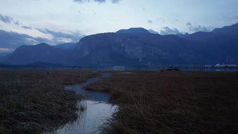 aerial-fly-above-narrowed-water-river-in-unpolluted-scenic-Canadian-mountains-landscape