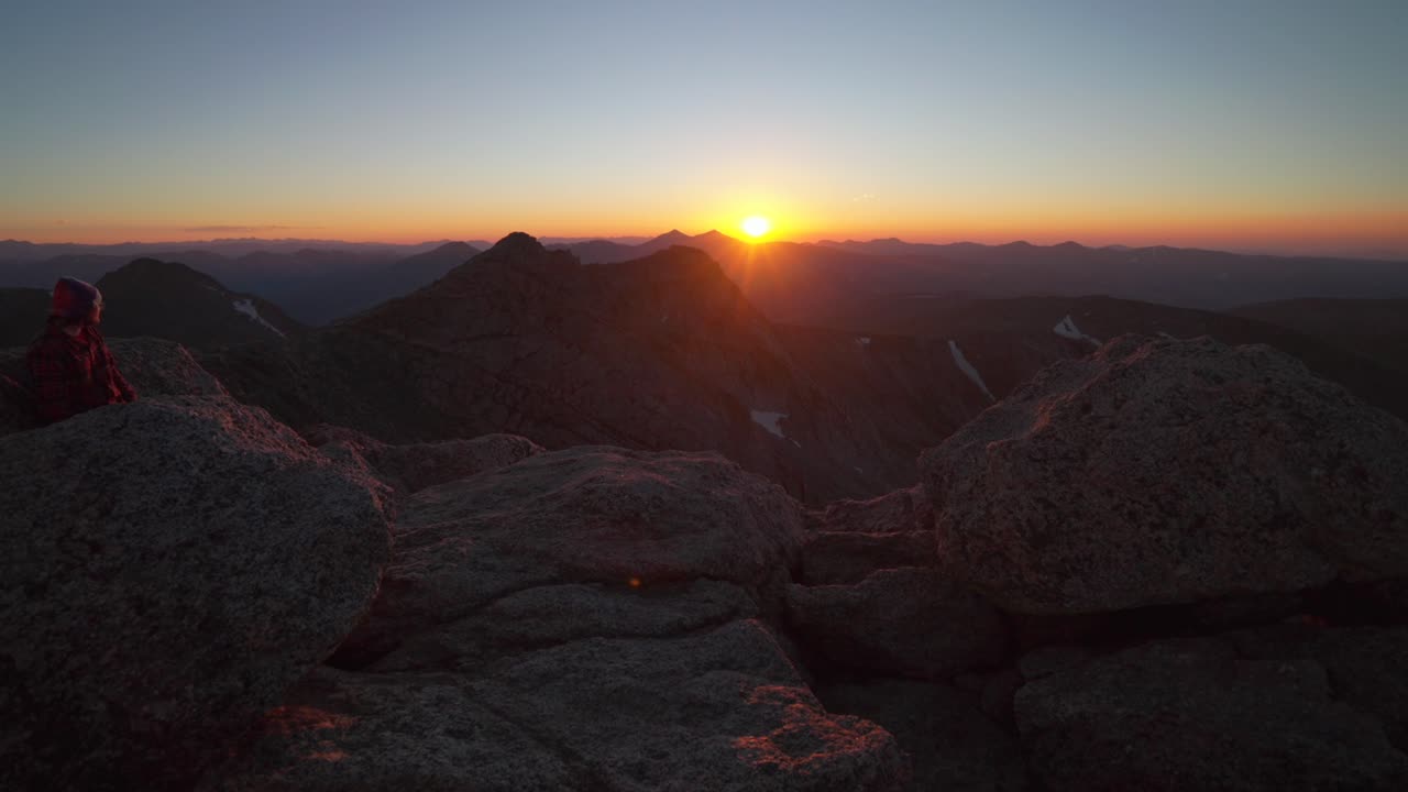 Person at Mount Blue Sky Evans last sunlight sunset sundown on horizon top Bierstadt Grays Torreys peak front range fourteener Rocky Mountains Colorado Grays Torreys Idaho Springs Evergreen pan right