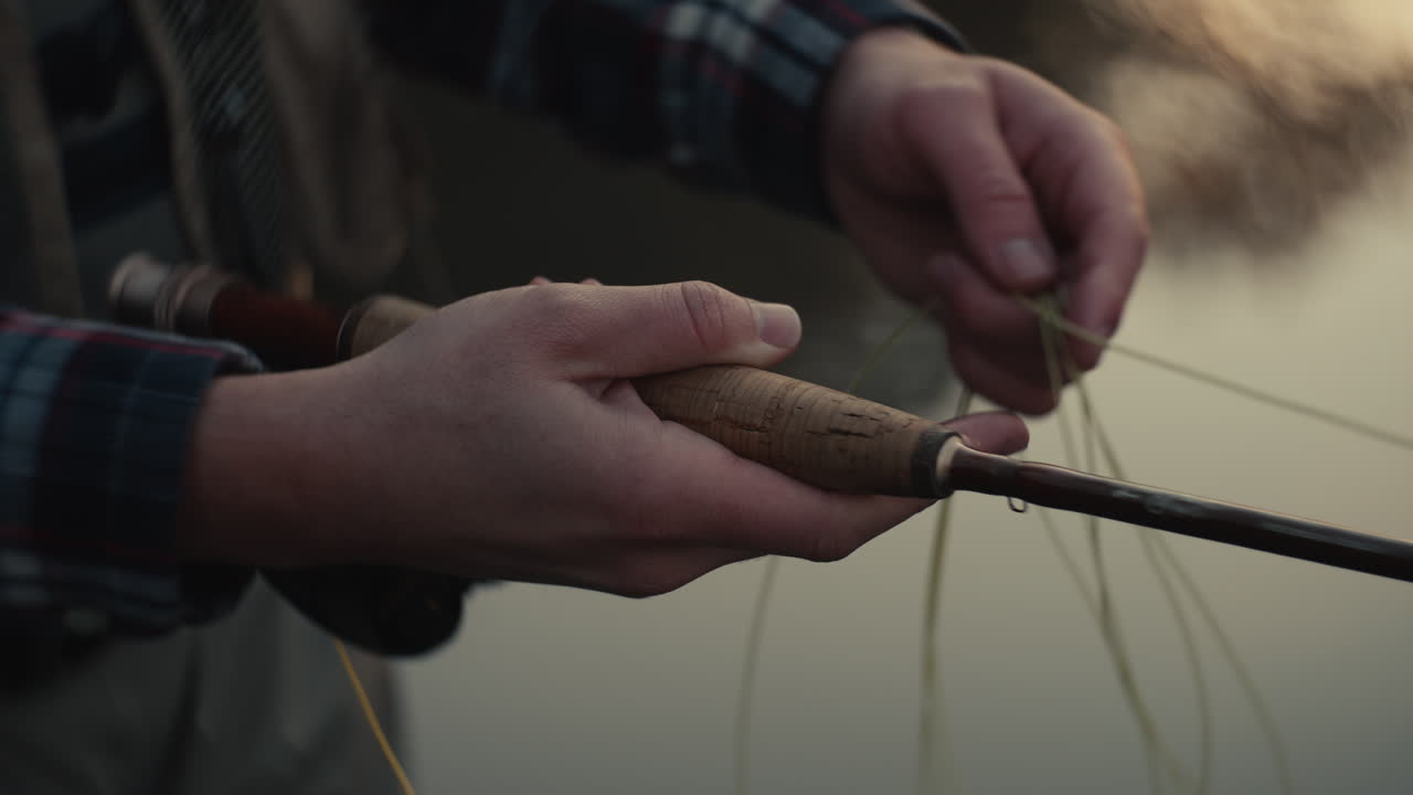 Person Tying a Fly Fishing Line