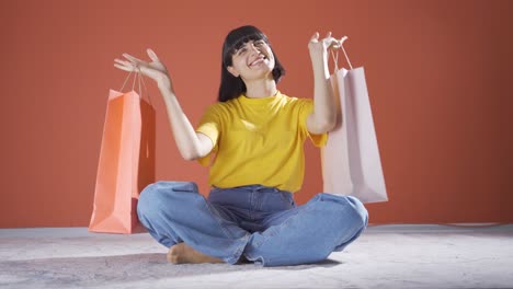 woman looking at camera with shopping bags.