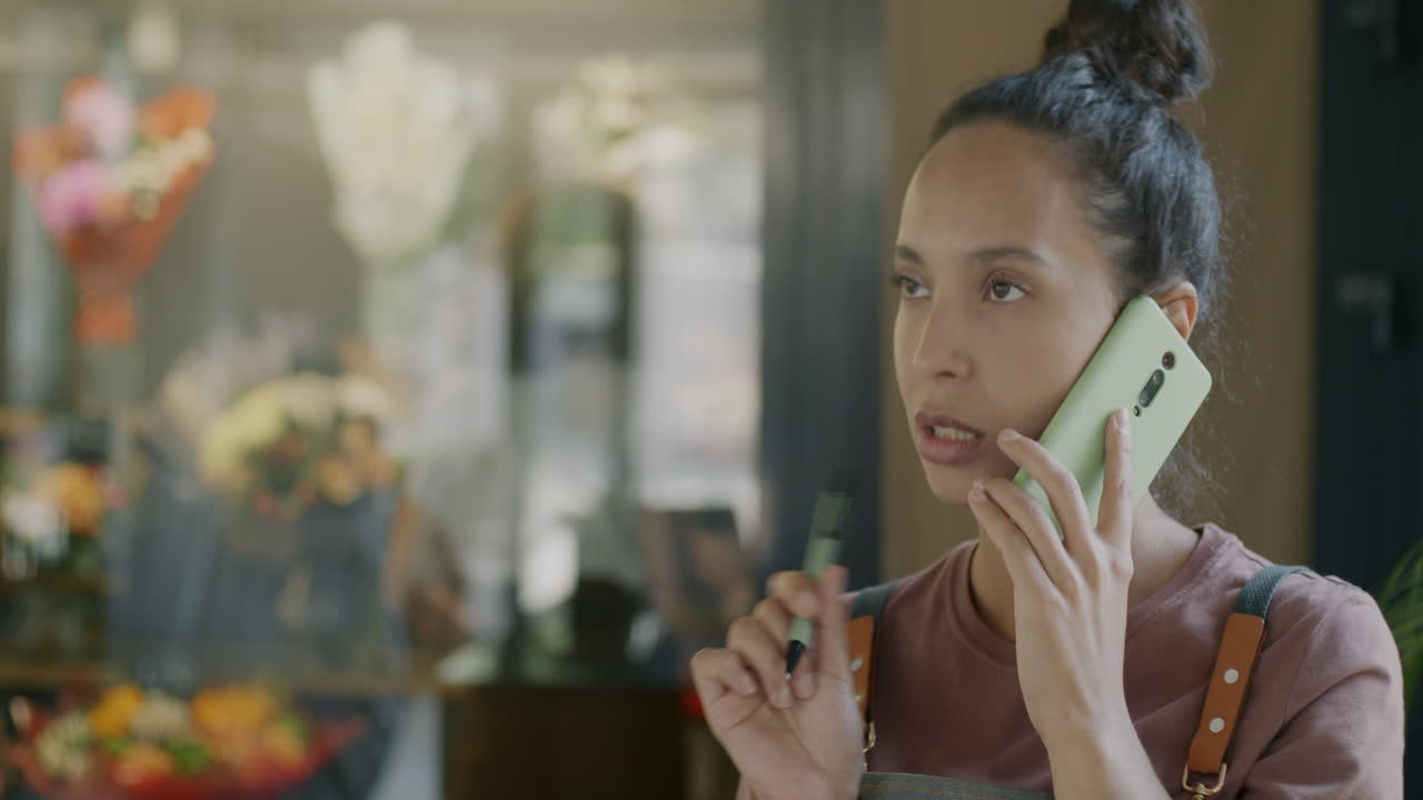 Woman Talking on Phone in a Floral Shop