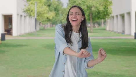 happy indian girl listening to songs and dancing