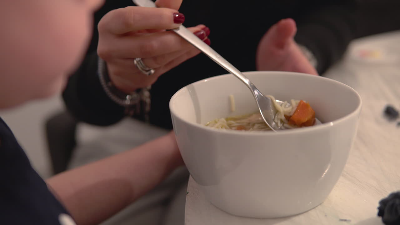 Person enjoying a bowl of homemade soup