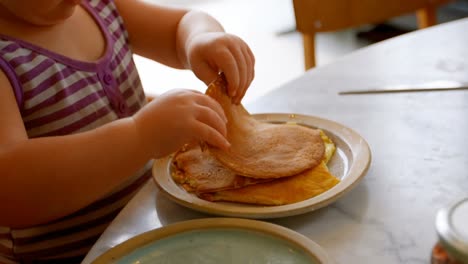 girl eating pancakes at home 4k