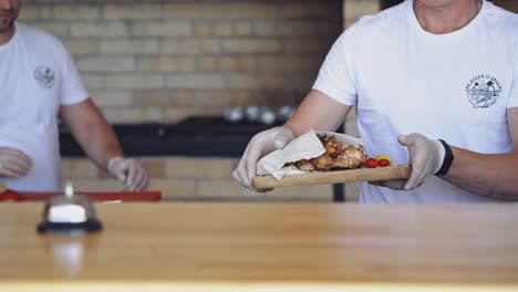 chef puts the ready meal on the table. cook putting hot delicious dish and presses the signal. dinner is ready in the restaurant. pleasant appetite.