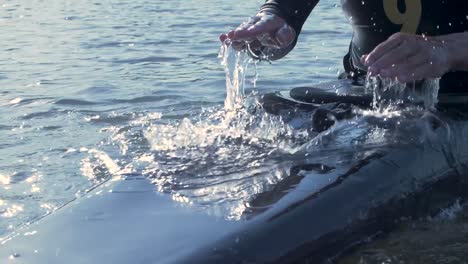 man in boat drums on his deck to cause splashing